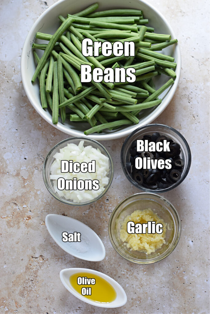 Ingredients to make green beans with black olives.