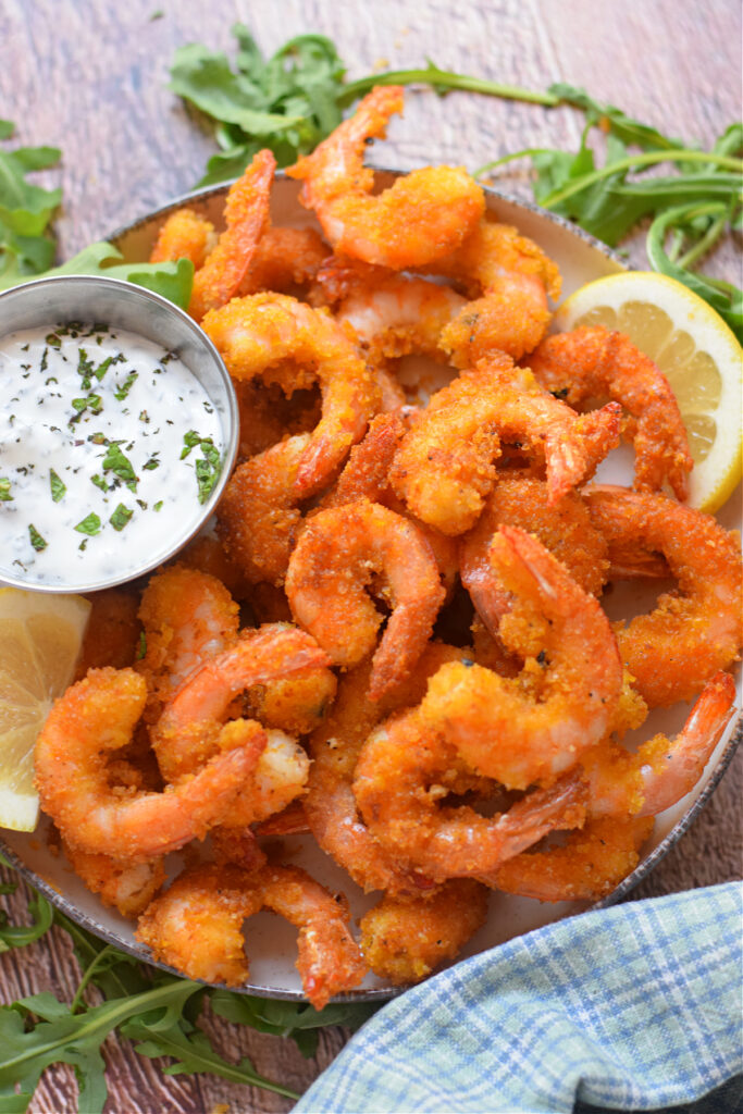 Fried shrimp on a plate with a dip.