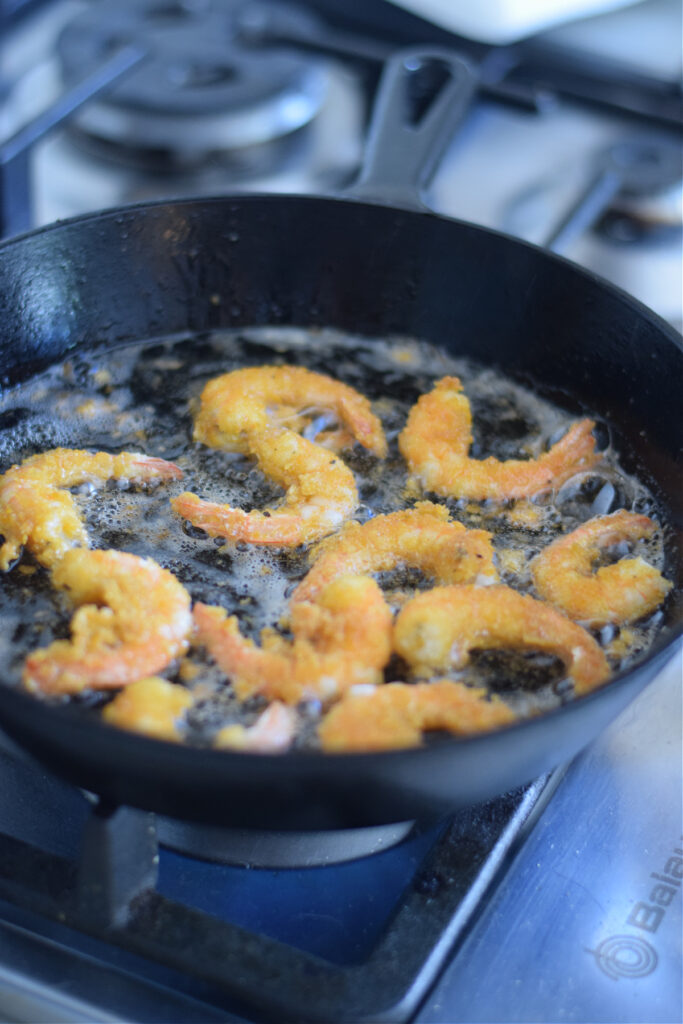 Cooking shrimp in a cast iron skillet.