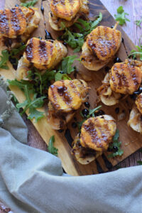Goat cheese bruschetta on a wooden board.