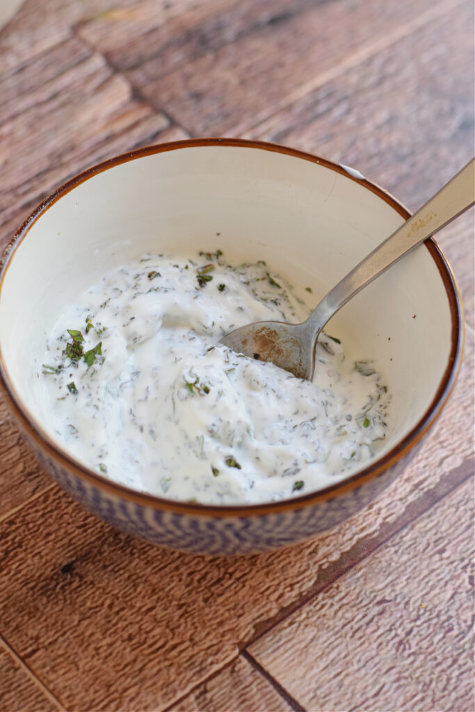 Minted yogurt dip in a small bowl.