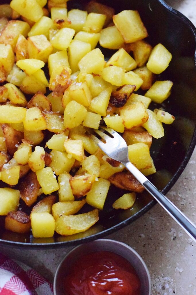 Skillet country fries in a cast iron pan.