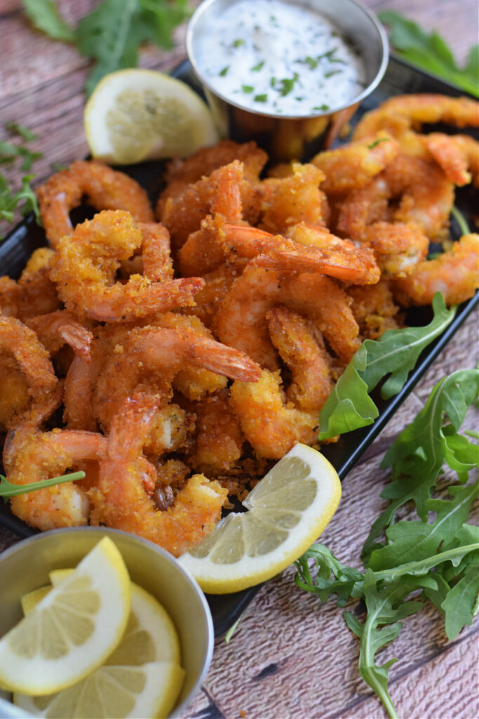 Crispy fried dip on a plate with lemons.
