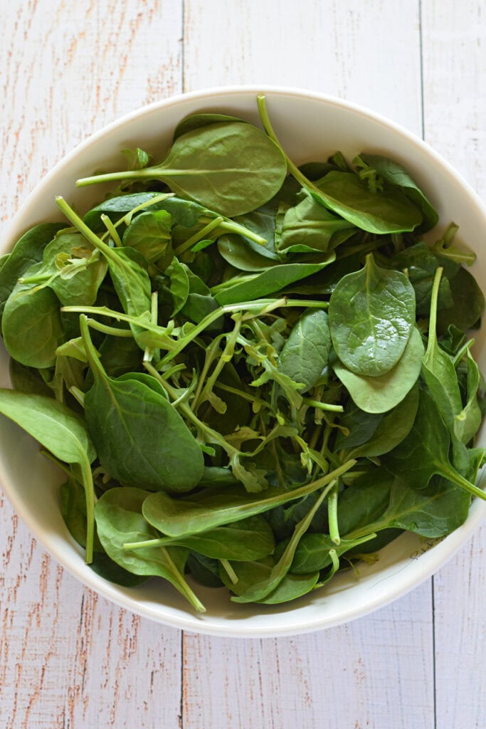 Salad leaves in a white bowl.