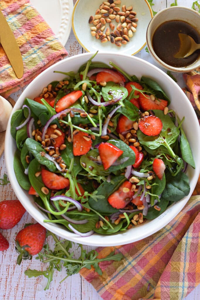Close up of a fresh salad in a white bowl.