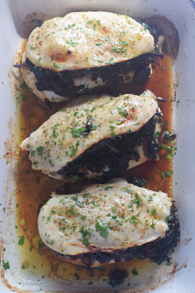 Stuffed chicken breast in a casserole dish.