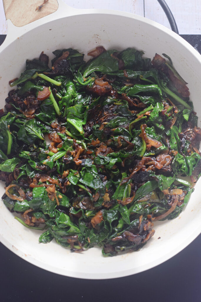 Spinach filling in a skillet.