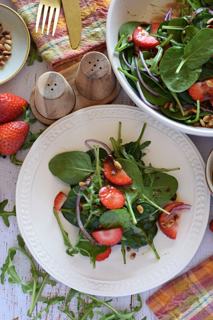 Strawberry salad on a small white plate.