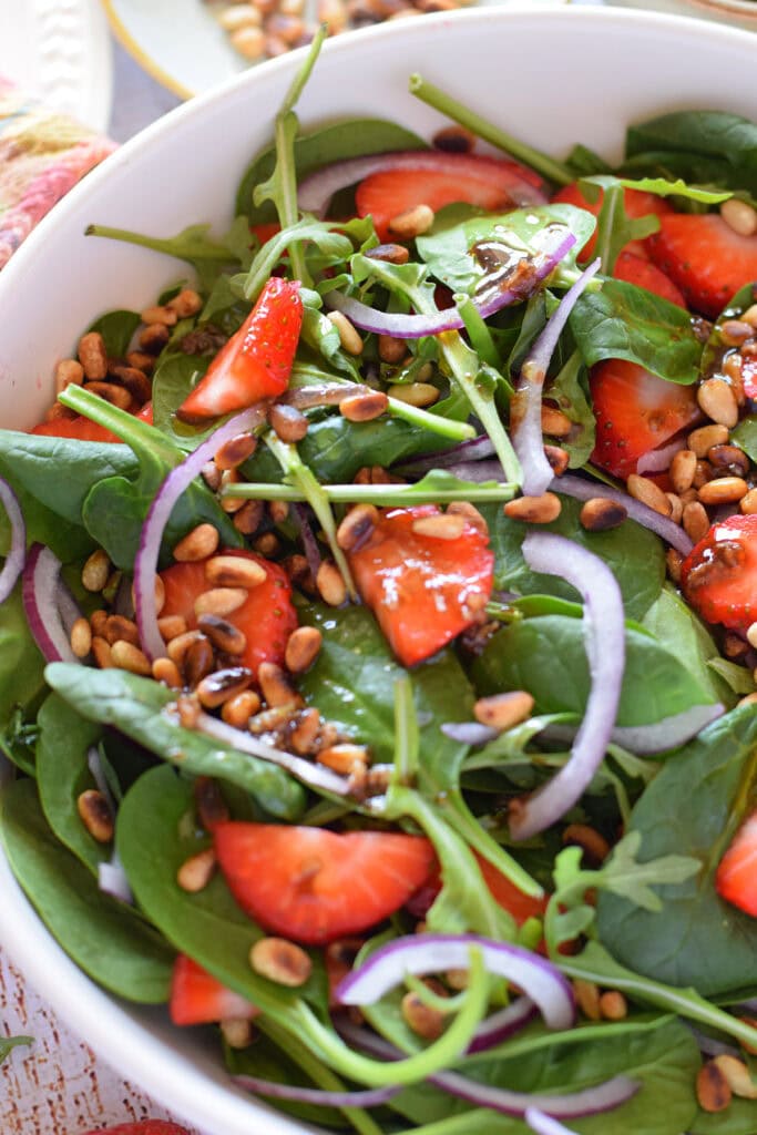 Close up of strawberry arugula salad.
