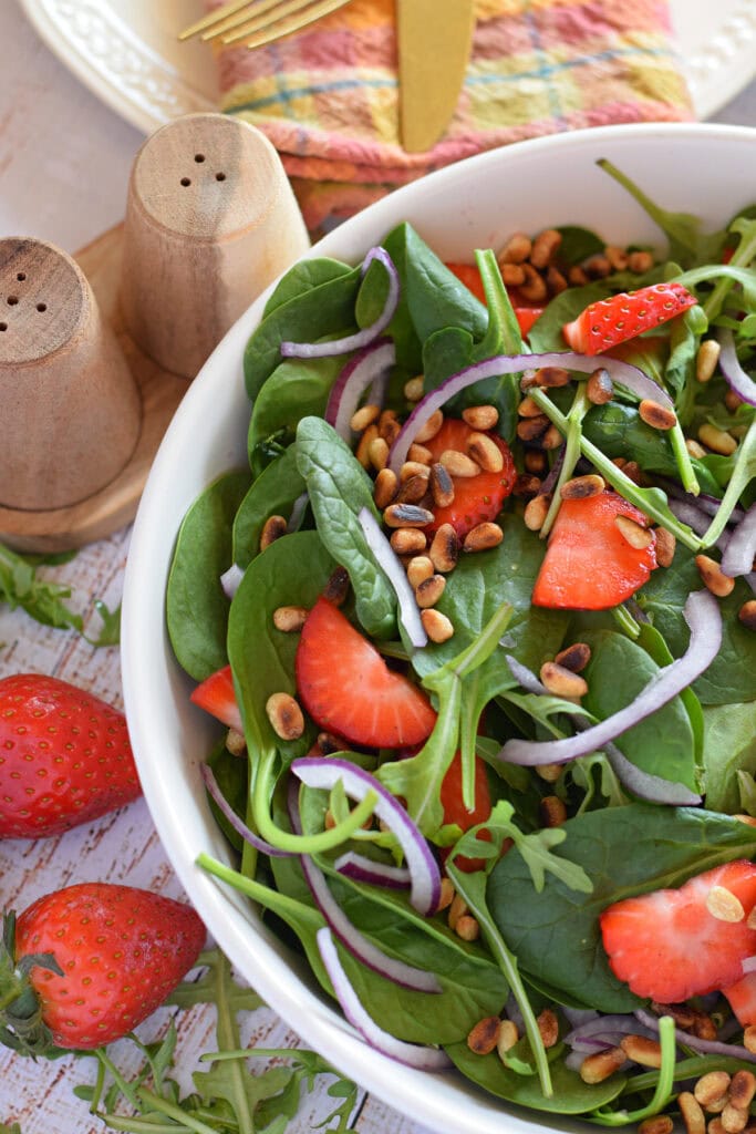 Close up of a strawberry spinach salad.