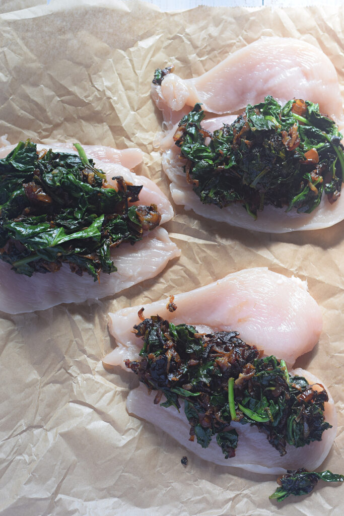 Adding filling to chicken breast.