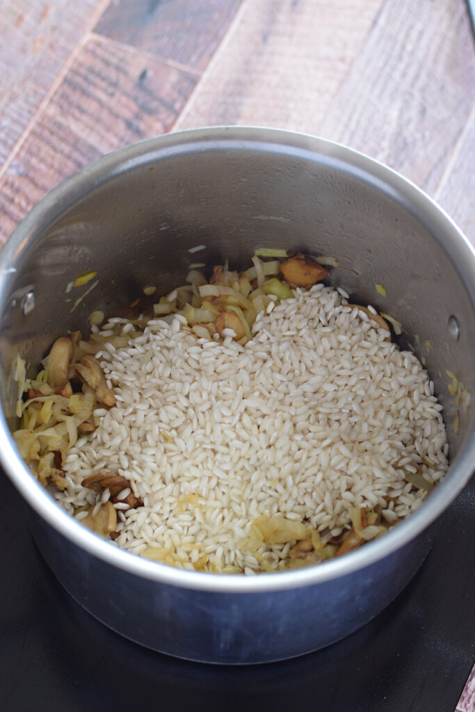 Adding rice to a saucepan.