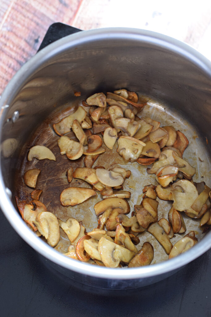 Cooked mushrooms in a saucepan.