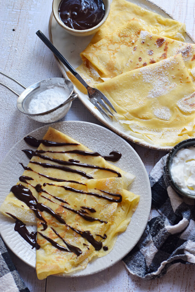 Chocolate dessert crepes on a plate.