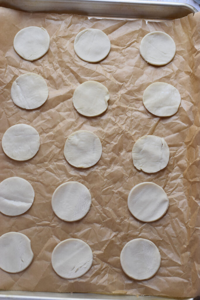 Pastry circles on top of a baking tray.