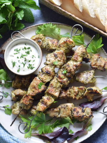 Chicken Kebabs with dip on a plate.
