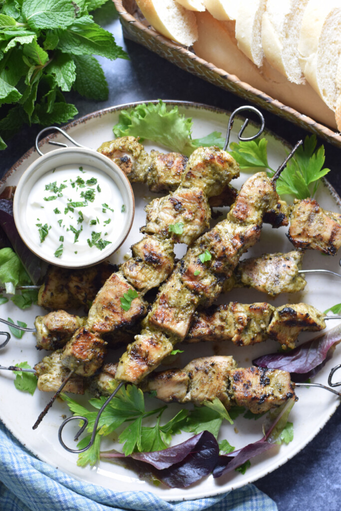 Chicken Kebabs with dip on a plate.