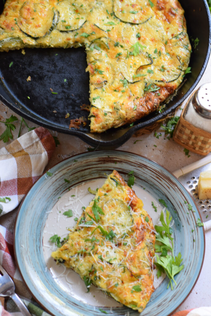 Zucchini and Parmesan frittata in a cast iron skillet.