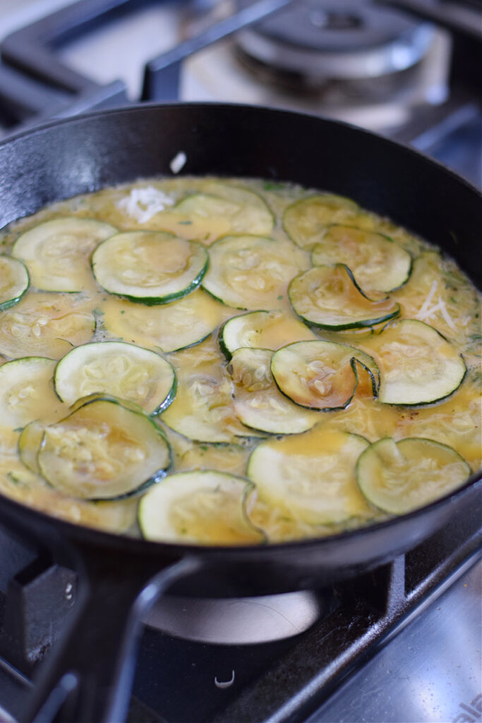 Making a zucchini frittata in a cast iron skillet.