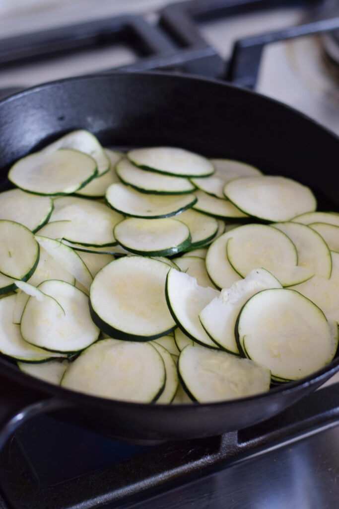 Cooking zucchini in a skillet.