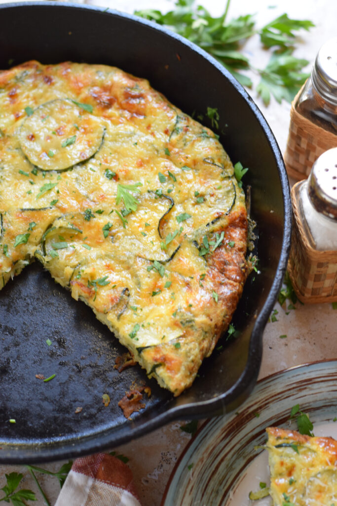 Zucchini parmesan frittata in a cast iron skillet.