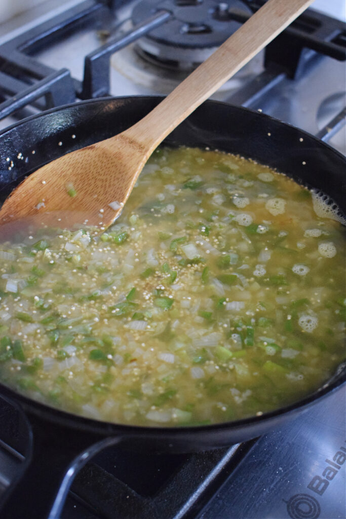 Cooking quinoa in vegetable broth.