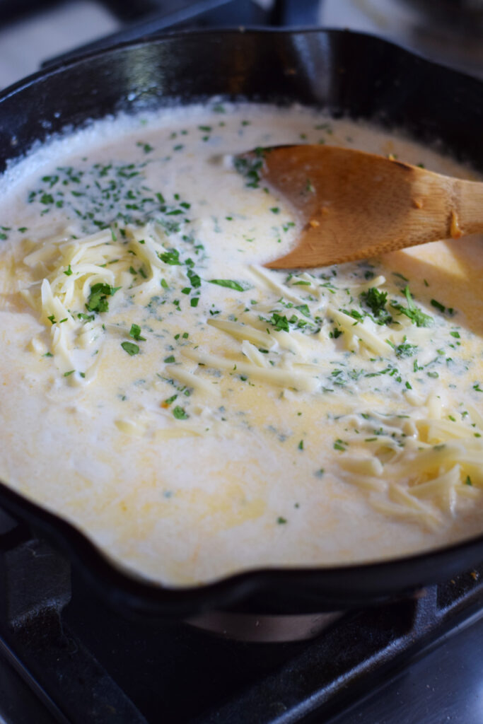 Making a cheese sauce for pasta.