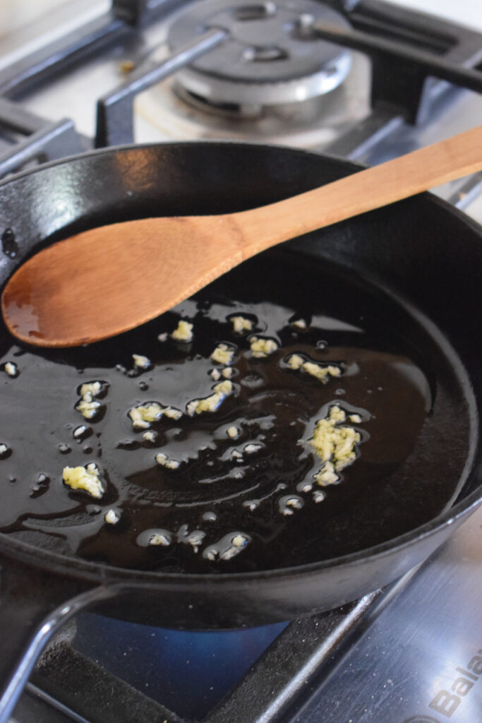Cooking garlic in a skillet.