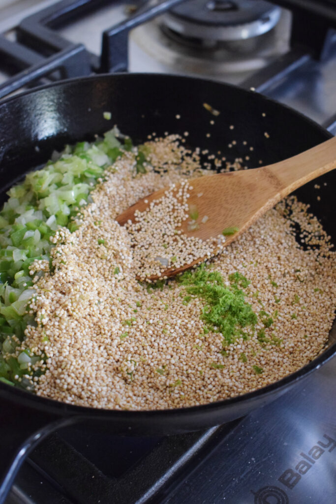 Adding lime zest to dry quinoa.