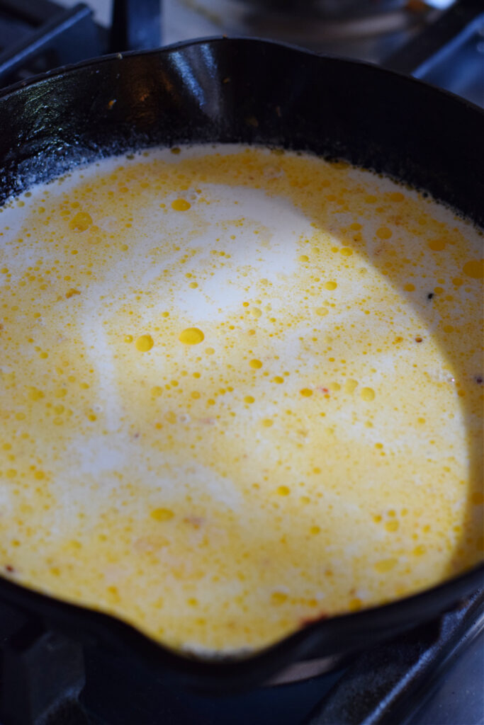 Making sauce in a skillet.