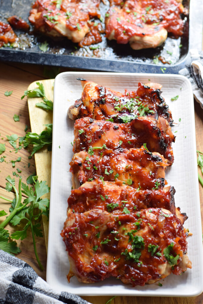 Oven barbecue chicken on a white plate.