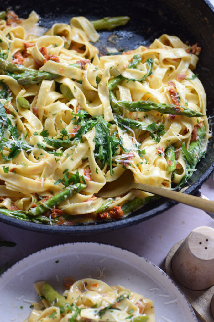 Close up of pasta with sun dried tomatoes and asparagus.