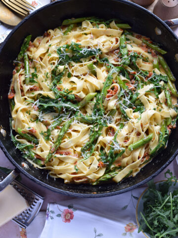 Sun dried tomato tagliatelle pasta in a skillet.
