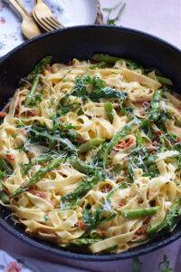 Sun dried tomato tagliatelle in a skillet.