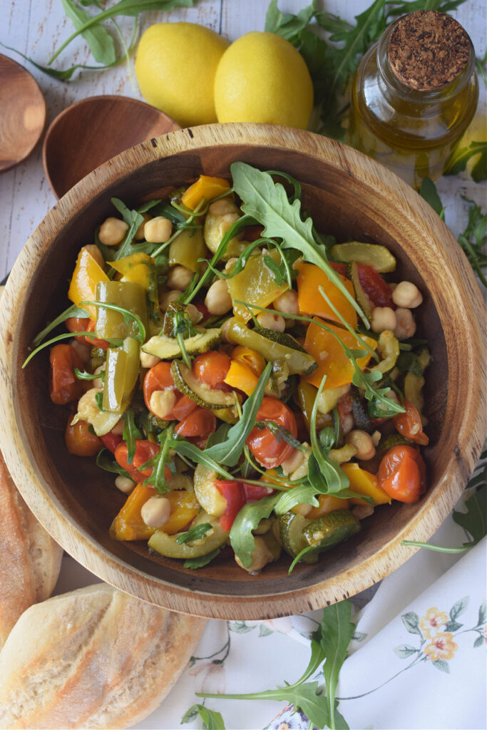 Warm mediterranean salad in a wooden bowl.