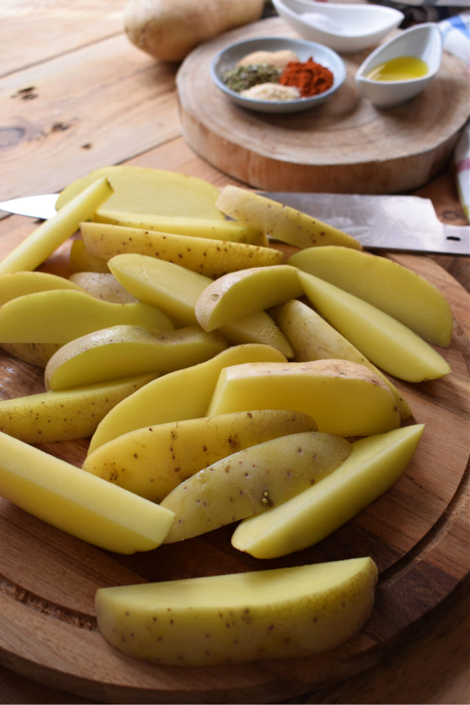 slices potatoes on a cutting board