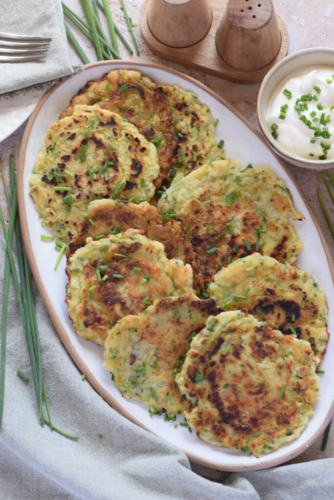 Zucchini fritters on an oval plate.