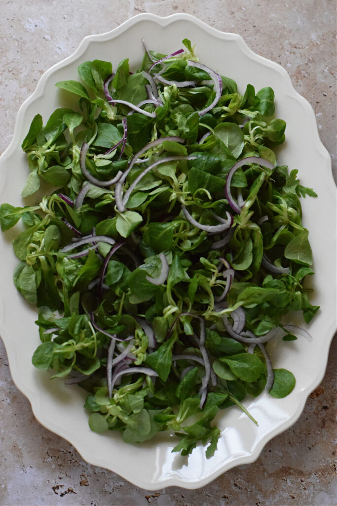 Salad greens on a large serving platter.