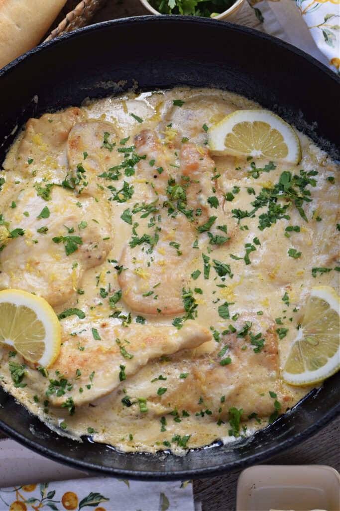 Creamy lemon chicken in a skillet.