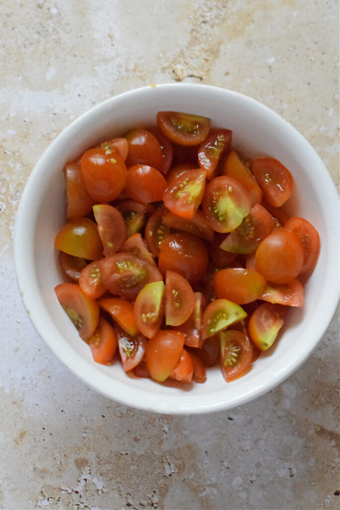 Diced cherry tomatoes in a bowl.