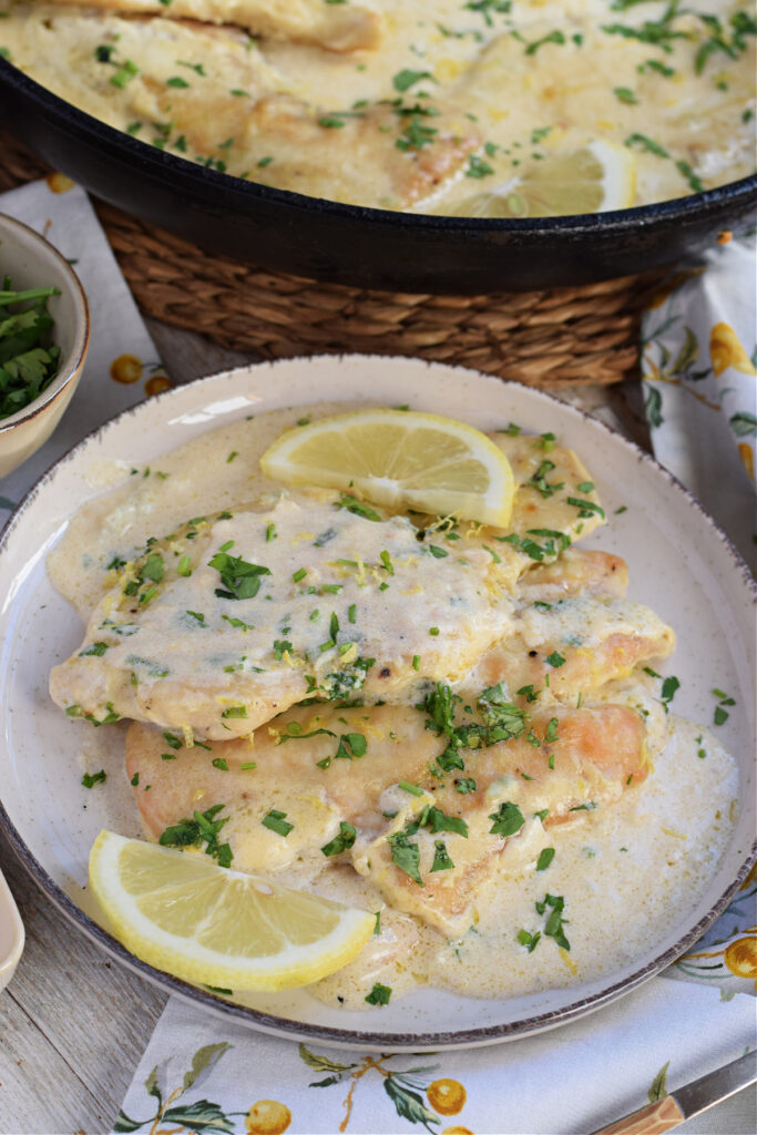 Lemon cream chicken on a plate.