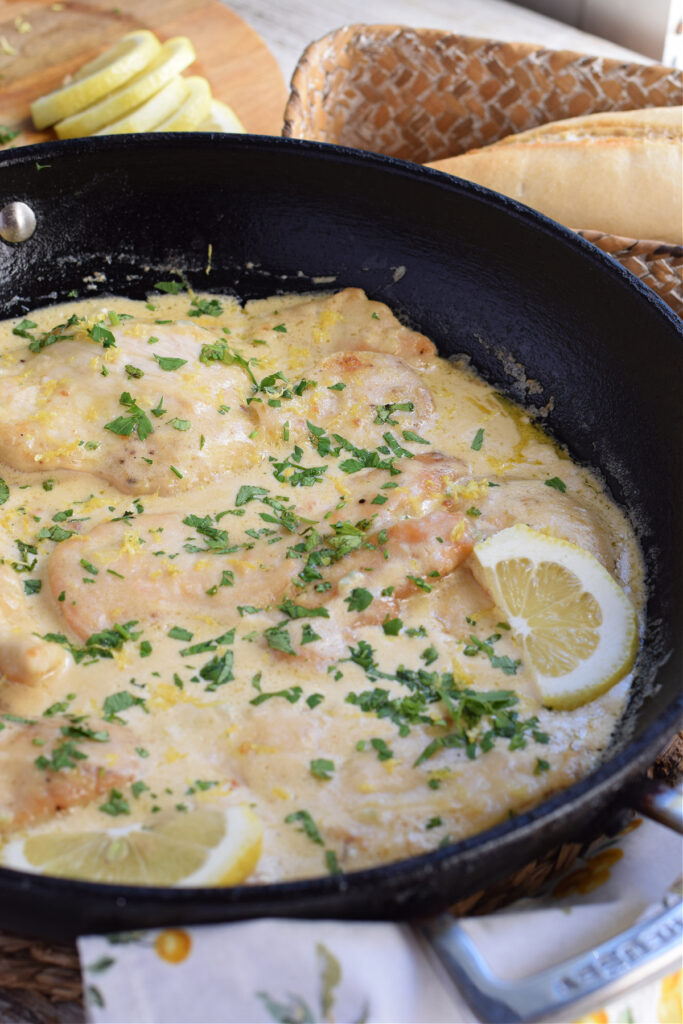 Lemon cream chicken in a skillet.