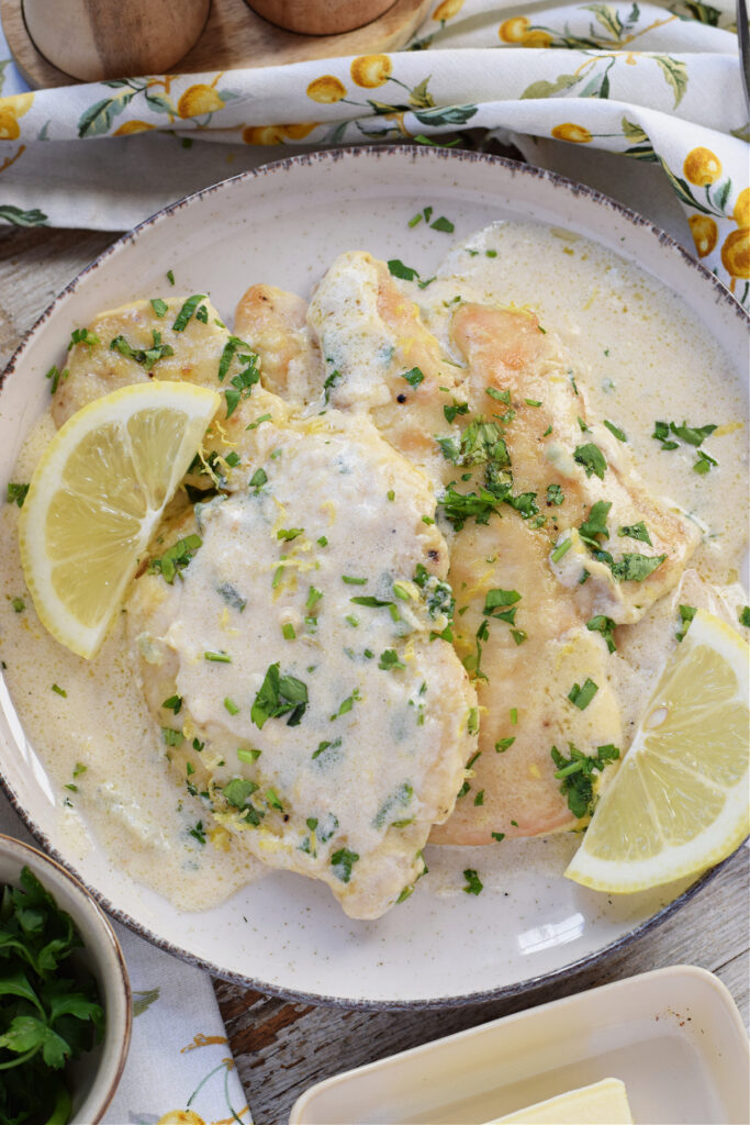 Close up of lemon cream chicken on a plate.