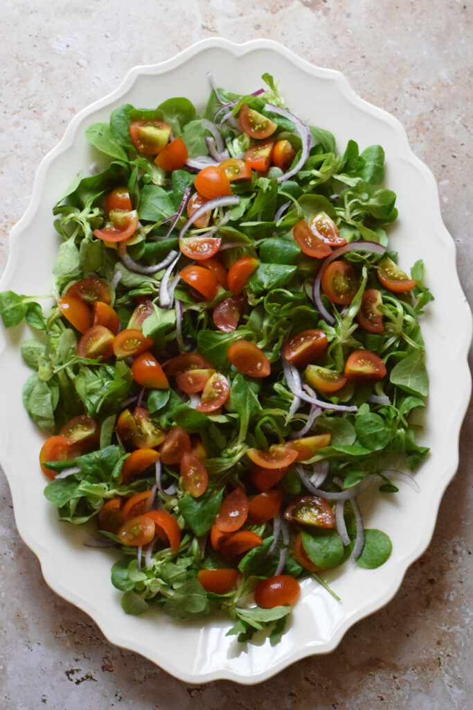 A green salad on a platter.