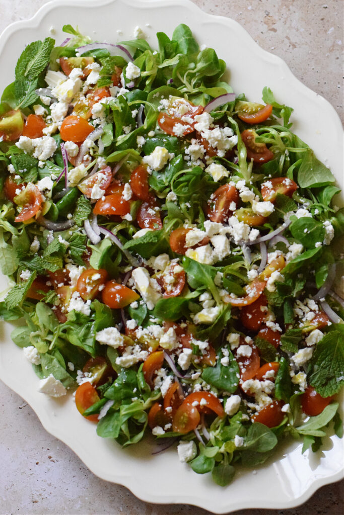 Green salad on a platter.