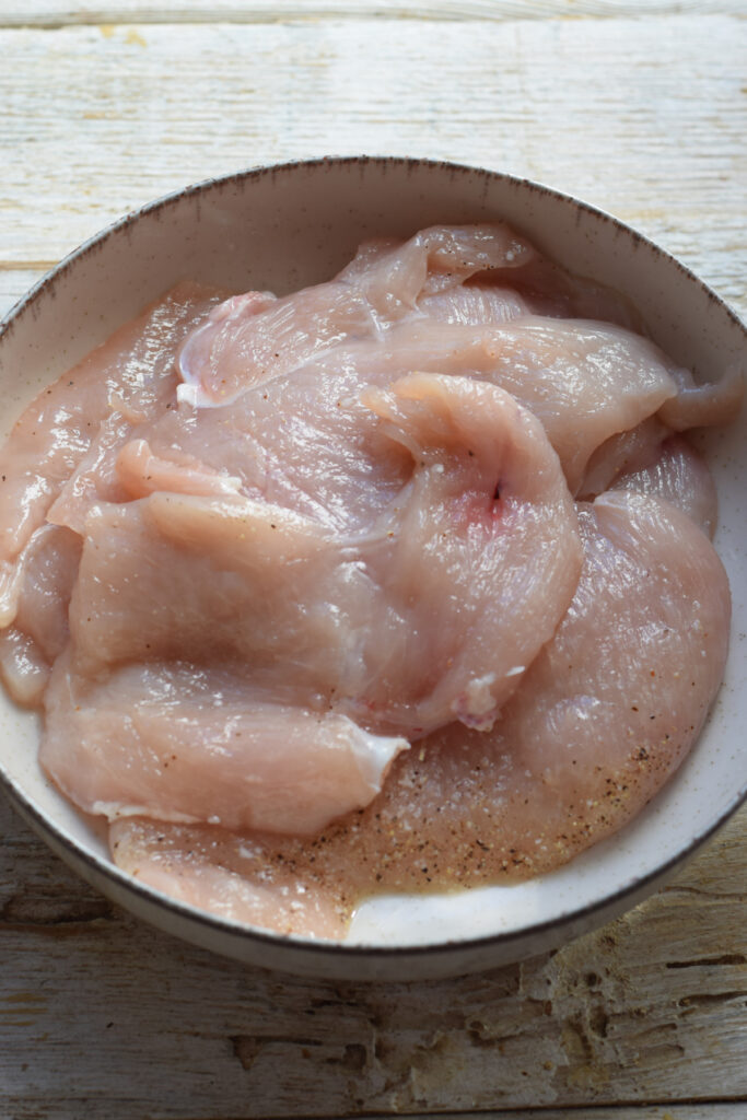 Seasoned chicken with salt and pepper.