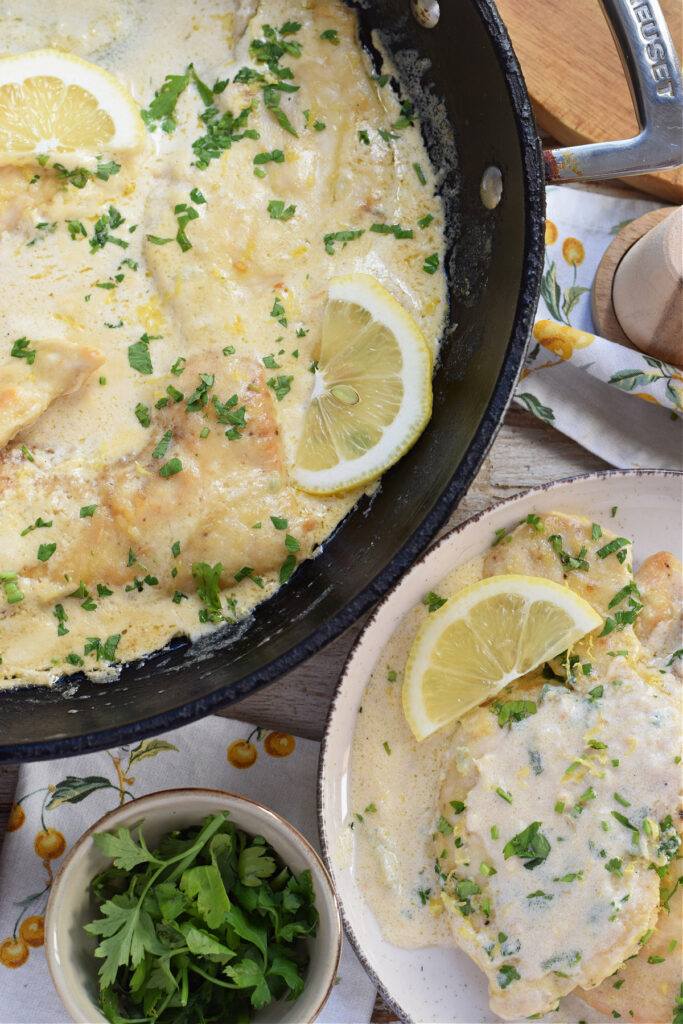 Lemon cream chicken in a skillet.