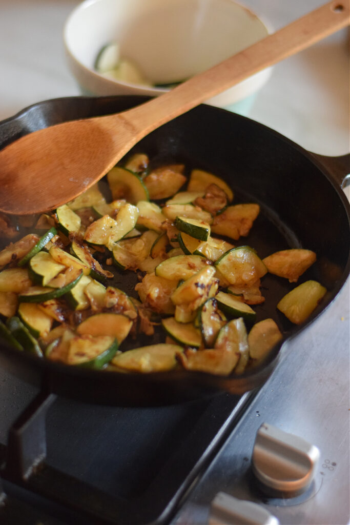 Cooked zucchini in a cast iron skillet.