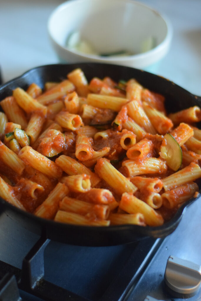 Pasta with tomato sauce in a skillet.