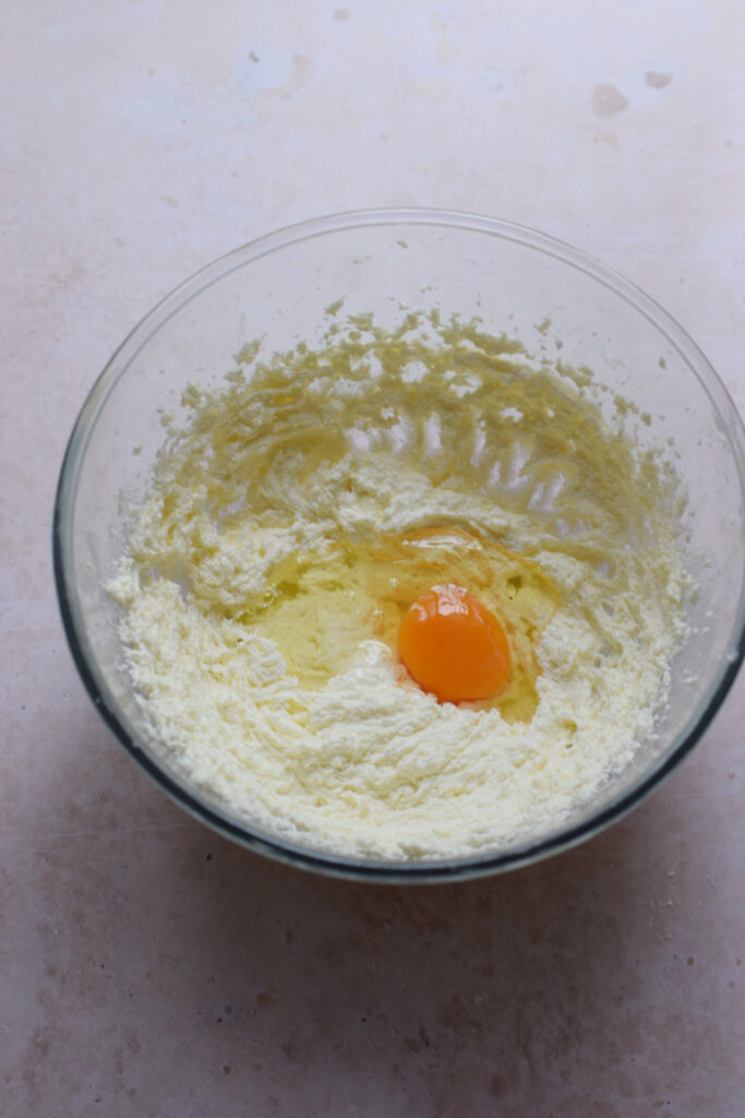 Adding eggs to cake batter.